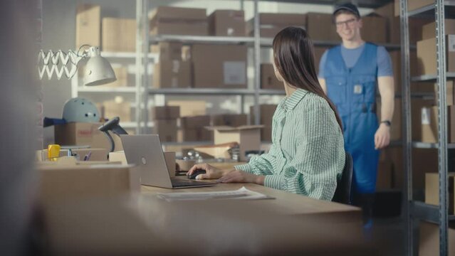 Online Store Inventory Manager Using Laptop Computer, Preparing a Small Parcel for Postage. Young Happy Delivery Service Worker Comes to Pick Up the Parcel from Small Business Owner.