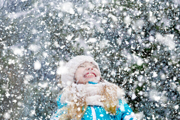 Snowy background with a happy little kid.