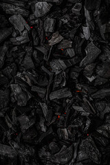 Charcoal with red streaks of heat. Textured dark back.