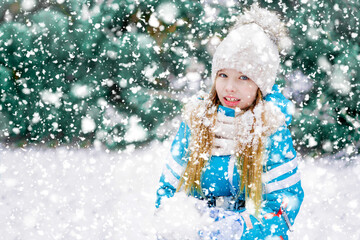 A pretty girl kid in heavy snowfall.