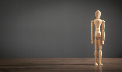 Wooden human figure on the table.