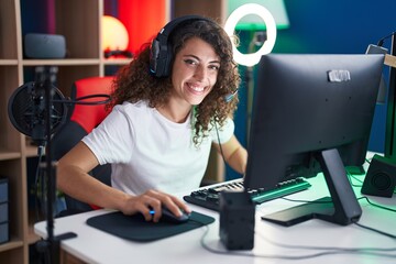Young beautiful hispanic woman streamer playing video game using computer at gaming room © Krakenimages.com
