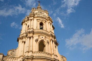 Fototapeta premium Closeup of the bell tower of the Duomo di San Giorgio, the mother church of the city of Modica in Sicily, Italy.