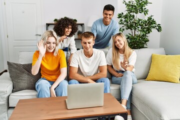 Group of young friends smiling happy having video call using laptop at home.