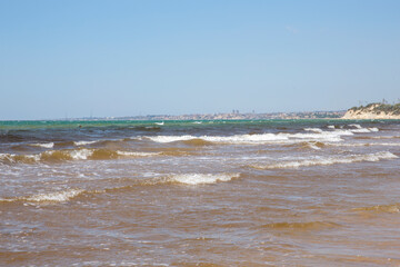 Seafront of Santa Maria del Focallo in Sicily, Italy. The waves of the sea and the beach are empty.