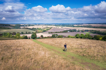 Hiking man walking in the field, Amazing view of Goring and Streatley, village town near Reading,...