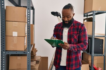 Young african american man ecommerce business worker organizing packages at office
