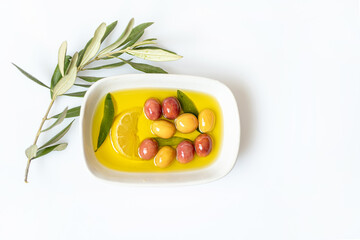 Olives and olive oil on a white background