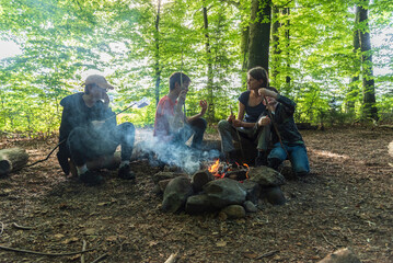 campfire in the woods. Mother and kids