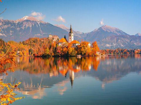 Beautiful church on a small island in the middle of lake Bled in autumn colors