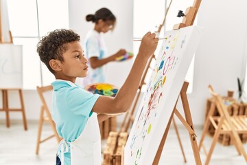 Brother and sister concentrate drawing at art studio