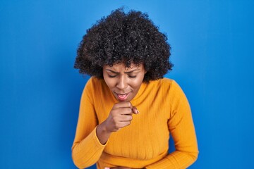 Fototapeta na wymiar Black woman with curly hair standing over blue background feeling unwell and coughing as symptom for cold or bronchitis. health care concept.