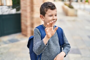 Blond child student smiling confident saying hello at street © Krakenimages.com