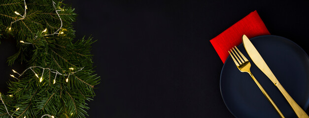 Christmas banner. Christmas ring or wreath and table setting on the black background. Copy space. Top view.