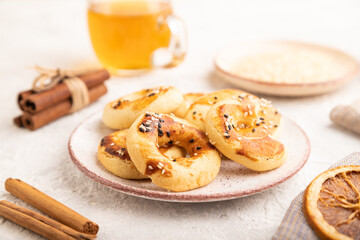 Homemade asian salted cookies, cup of green tea on gray concrete, side view, selective focus.