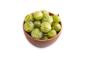 Fresh green gooseberry in clay bowl isolated on white, side view.