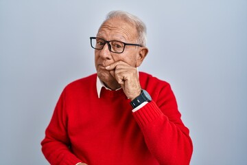 Senior man with grey hair standing over isolated background mouth and lips shut as zip with...