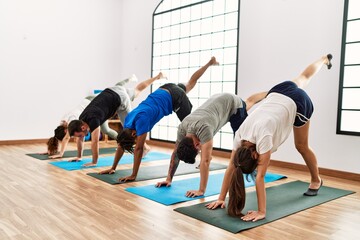 Obraz premium Group of young sporty people concentrate training yoga at sport center.