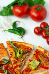 vegetarian pizza with cheese, tomato, pepper and avocado in white wooden desk.Top view