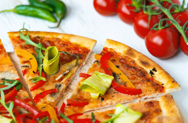 vegetarian pizza with cheese, tomato, pepper and avocado in white wooden desk.Top view