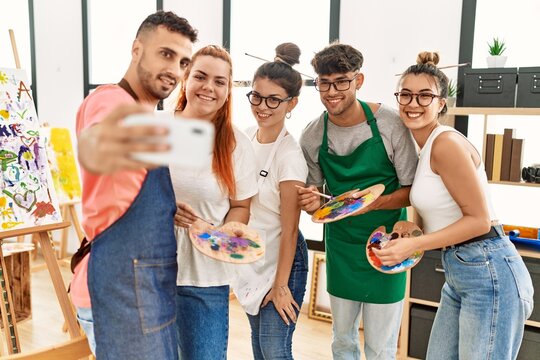 Group of young paint students smiling happy make selfie by the smartphone at art studio.