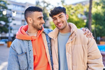 Naklejka premium Two man couple hugging each other standing at park