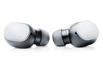 two wireless in-ear headphones lying on a white isolated background