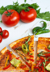 vegetarian pizza with cheese, tomato, pepper and avocado in white wooden desk.Top view
