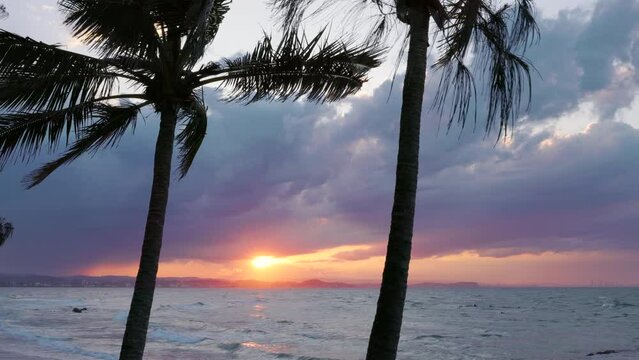 a shot of the sun setting looking from greenmount beach in coolangatta towards the gold coast in queensland, australia