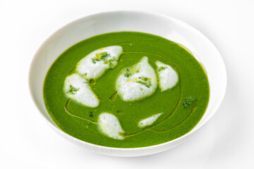 Fragrant first course from spinach, aromatic herbs and cream. Vegetarian dietary cream soup based on baked and fresh vegetables with herbs. Fitness menu. Delivery of prepared food. White background