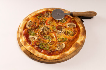 Pizza with tomato sauce, mushroom peppers, cherry tomatoes and grated cheese on wood