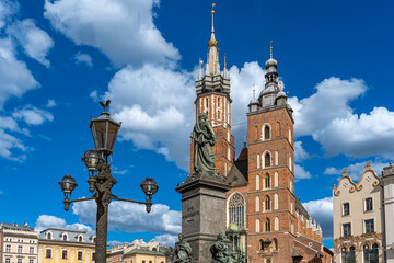 Historic center of Krakow. Vintage lamppost, Adam Mickiewicz monument, St. Mary's Church and market...