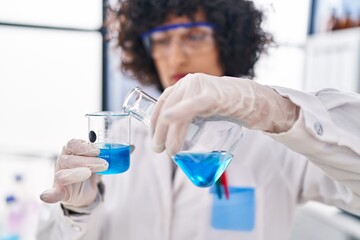 Young middle east woman scientist measuring liquid at laboratory
