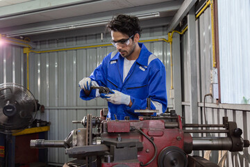 An auto mechanic is measuring the size of a brake disc that needs to be partially grinded.
