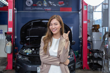 A car mechanic is checking items that need replacement parts for a customer who repairs a car at a...