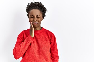 Fototapeta na wymiar Young african american woman wearing casual clothes over isolated background touching mouth with hand with painful expression because of toothache or dental illness on teeth. dentist