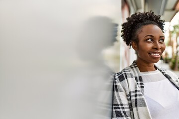 Young african american girl smiling happy standing at the city.