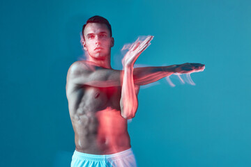 Sportive male with naked muscular torso stretching arms muscles. Sport workout, warm up, gym. Long...