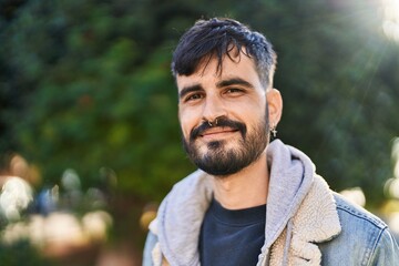 Young hispanic man smiling confident standing at park