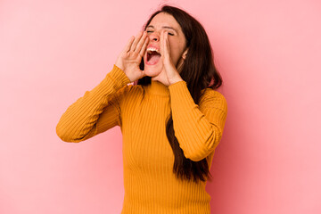 Young caucasian woman isolated on pink background shouting excited to front.