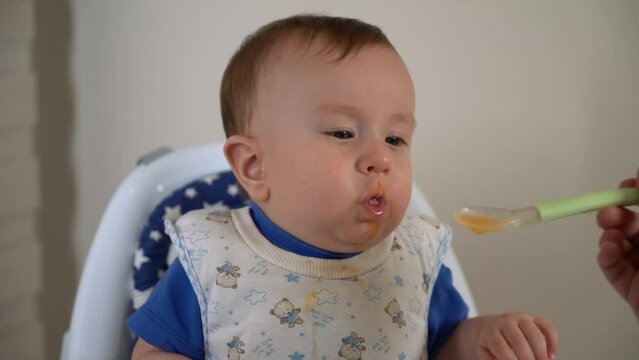 Baby coughing while drinking soup.