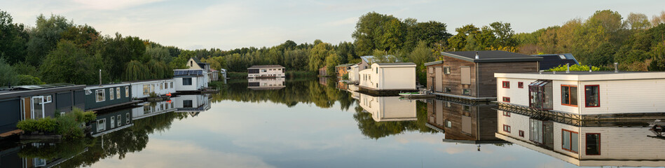 Dutch village Halfweg, part of the municipality of Haarlemmermeer, panoramatic view of recreational area with houseboats