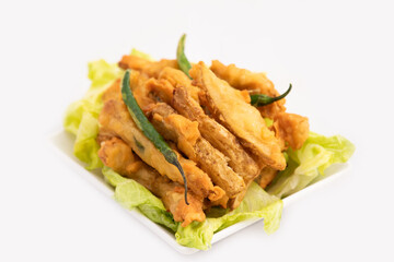 Indian Street Food Sliced Crispy Fried Potato Wedges Also Called Aloo Bhajji, Alu Bajji, Aaloo Pakoda or Pakora Made Of Bengal Gram Flour Besan Coating Are Famous Tea Time Evening Time Appetizer