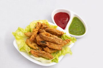 Indian Street Food Sliced Crispy Fried Potato Wedges Also Called Aloo Bhajji, Alu Bajji, Aaloo Pakoda or Pakora Made Of Bengal Gram Flour Besan Coating Are Famous Tea Time Evening Time Appetizer