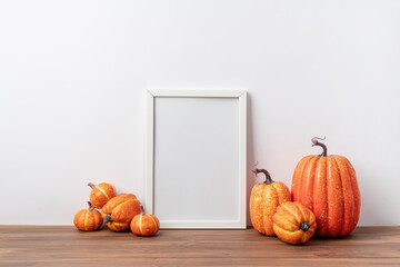Art photo frame mockup with scarfs and autumn leaves, white background