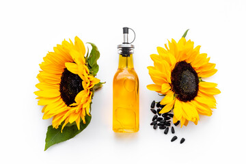 Blooming yellow sunflowers with cooking oil and black seeds, top view