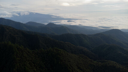Obraz premium Aerial view of sea of fog on tropical mountains in the early morning.