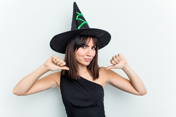 Young caucasian woman dressed as a witch isolated on white background feels proud and self confident, example to follow.