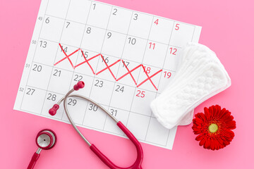 Women health. Stethoscope and calendar with red days of menstruation period