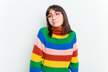 Young caucasian woman isolated on white background shrugs shoulders and open eyes confused.